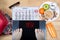 Digital scales with female feet sign `yes!` surrounded by calendar, summer accessories and plate with healthy food.