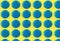 Digital seamless pattern with blue circles on yellow background. Repeating elements