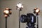 Digital SLR camera and three spotlights with Fresnel lenses. Manual interchangeable lens for filming