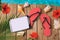 Digital tablet, flip flops and hibiscus flowers on wooden background. Summer holiday vacation concept. View from above