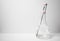 A digital thermometer measuring the temperature of a liquid in a glass erlenmeyer flask on a white background.