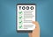 Digital todo list concept with hand holding smart phone