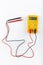 Digital yellow multimeter meter isolated to check the resistance on a white background