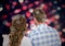 Digitally generated image of couple standing against bokeh background with hearts