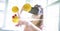 Digitally generated image of emojis flying over against woman using VR glasses at home