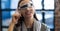 Digitally generated image of various graphics against woman using VR glasses in office