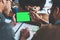 Digitizing the planning process. a businessman using a digital tablet with a green screen during a meeting at work.