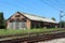 Dilapidated abandoned railway station building with missing roof tiles and windows