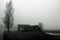 Dilapidated barn in fog