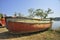 Dilapidated boats parked near creeks shore