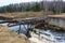 The dilapidated bridge over the small tumultuous river.