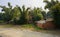 Dilapidated cottages in bamboo by unpaved road in sunny winter