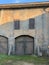 Dilapidated facade of old warehouse. Wooden gate with old paint. Dirty walls