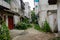 Dilapidated houses along unpaved alleyway