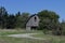 A Dilapidated Old Barn At The End Of A Road