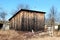 Dilapidated old wooden tool shed and storage area built in abandoned suburban family house backyard