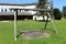 Dilapidated old wooden vintage outdoor public playground equipment in shape of swing with two seats in abandoned office building