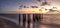 Dilapidated ruins of a pier on Port Royal Beach at sunset