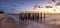 Dilapidated ruins of a pier on Port Royal Beach at sunset