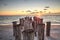 Dilapidated ruins of a pier on Port Royal Beach at sunset