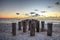 Dilapidated ruins of a pier on Port Royal Beach at sunset