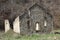 Dilapidated stone building in a field. Old mill in the fall. A stark background