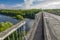 Dilapidated unsafe bridge over river. Abandoned building of emergency condition