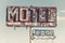 A dilapidated, vintage motel sign in the desert of Arizona