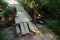 A dilapidated wooden bridge over a forest river. Dangerous river crossing