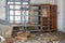 Dilapidated wooden shelf bookcase in abandoned office
