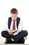 A diligent boy reads a book and prepares for exams and tests. Schoolboy teenager dressed in a school uniform. Isolated white