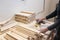 Diligent female carpenter sanding wood at the workshop