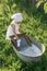 A diligent girl helps her mom with homework, washing clothes in a basin