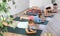 Diligent preteen boy practicing plank pose of yoga with his family