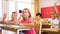 Diligent preteen schoolgirl raising hand to answer at lesson