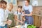 Diligent teen girl helping family to cook, grate cheese, in kitchen at home