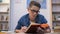 Diligent teenage student in glasses preparing to exams in college, deadline