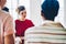 Diligent woman looking down in multiracial group of people