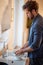 A diligent young man washing dishes in the kitchen. Kitchen, housework, quarantin, home