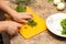 Dill cutting with a knife on the board