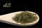 Dill on wooden spoon isolated on black background. Latin name Anethum graveolens