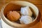 Dim sum dumplings served in small steamer basket