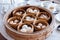 Dim sum set: Barbecued pork bun, Shrimp dumpling, Sweet cream buns, Shrimp shumai topping with goji berry served in steamer basket