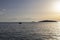 Dinghy gliding on the sea surface at sunset, off the shore of small tourist town of Rogoznica, Croatia on the eastern coast of