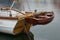 Dinghy, small rowing boat made of mahogany wood, attached to the stern of a sailing yacht