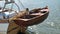 Dinghy, small rowing boat, made of mahogany wood, attached to the stern of a vintage sailing yacht. Schleswig-Holstein, Germany