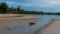 Dinghy in tidal pool at low tide aground with anchor trailing behind