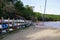 Dingy boat under water over winter racked one above on dry rack boats on sand lake beach