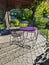 Dining alfresco with purple and black iron table and chairs