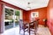 Dining area with bright red walls and walkout patio